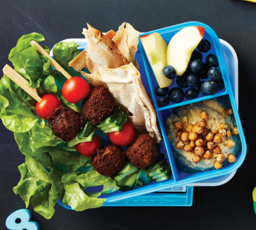 Falafel kebabs with pita chips, hummus and fruit